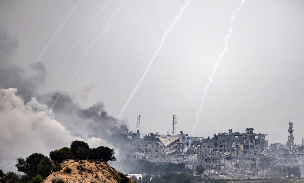 This image taken from the Israeli border with the Gaza Strip on October 29, 2023, shows a black cloud of smoke ascending from the Gaza Strip amid the ongoing battles between Israel and the Palestinian group Hamas. The Israeli army has raised the number of troops fighting inside the Gaza Strip, a spokesman said on October 29, 2023, as the military stepped up its war on Hamas in the tiny Palestinian territory. Thousands of civilians, both Palestinians and Israelis, have died since October 7, 2023, after Palestinian Hamas militants based in the Gaza Strip entered southern Israel in an unprecedented attack triggering a war declared by Israel on Hamas with retaliatory bombings on Gaza. (Photo by FADEL SENNA / AFP)