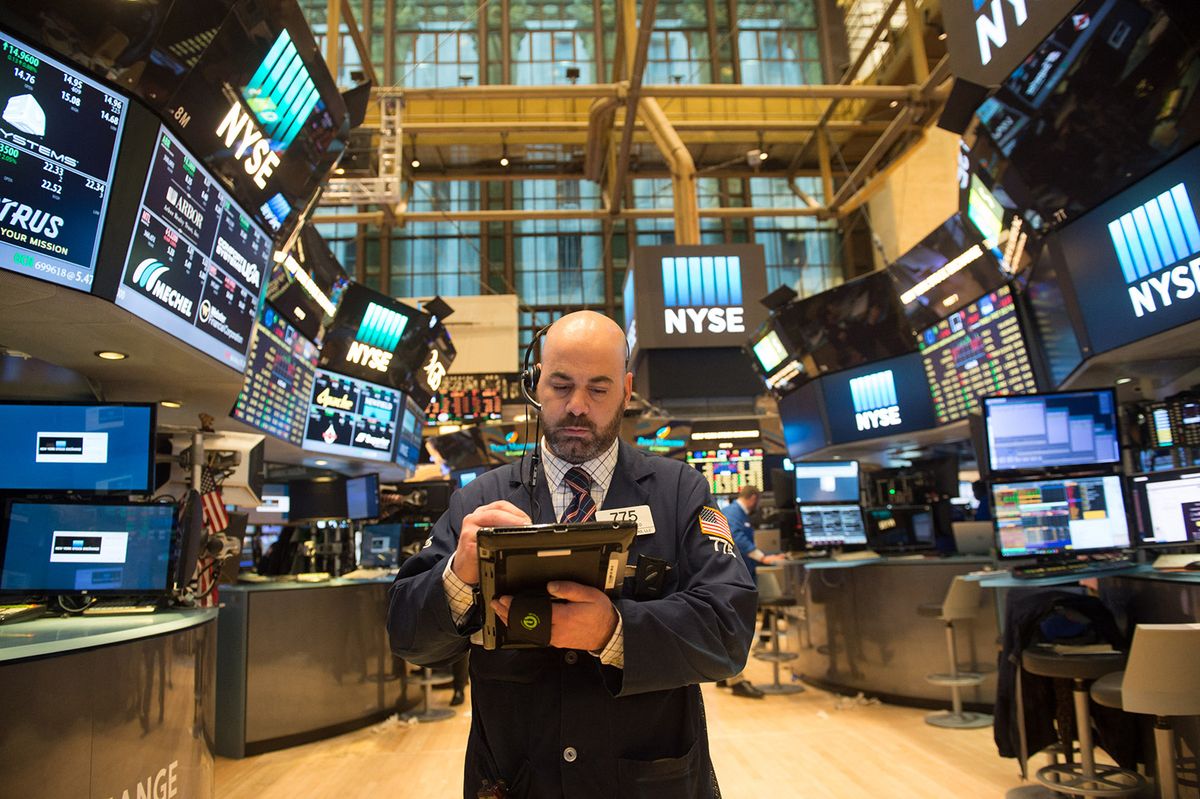 A trader works on the floor at the closing bell of the Dow Jones at the New York Stock Exchange, March 31, 2017 in New York. Wall Street finished a strong quarter with a whimper Friday, with major indices ending lower as US President Donald Trump promised to fight trading partners that short-change the United States. (Photo by Bryan R. Smith / AFP)