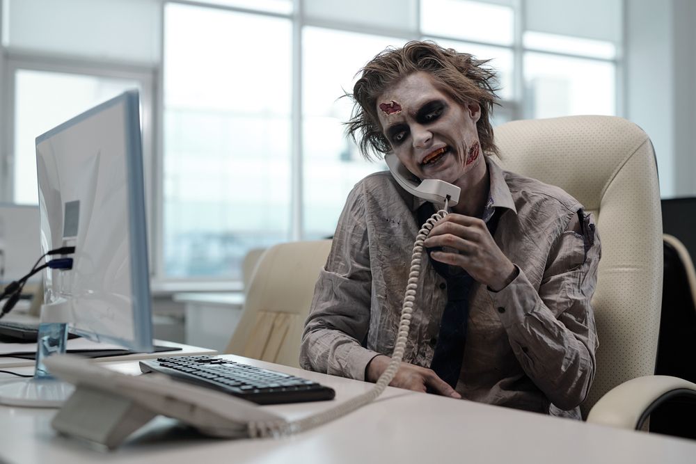 Zombie,Businessman,With,Phone,Receiver,Between,His,Shoulder,And,Cheek