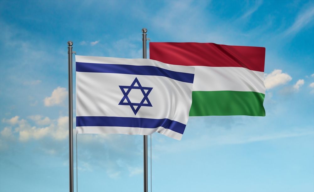 Hungary,Flag,And,Israel,Flag,Waving,Together,On,Blue,Sky,