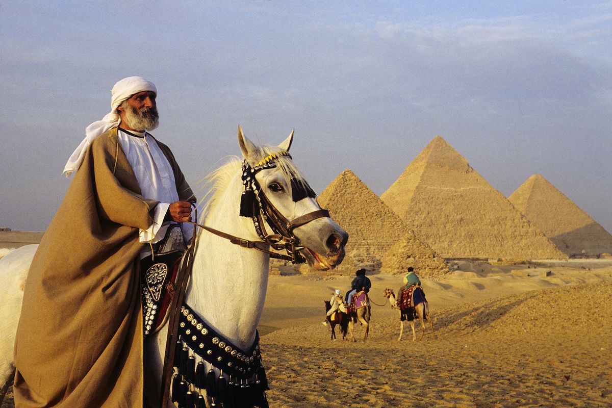 Egypt. Cairo. Pyramids of Giza. A horse rider in front (Photo by Gerard SIOEN / ONLY WORLD / Only France via AFP)