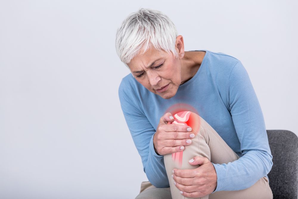 Elderly woman holding knee with pain. Elderly age health