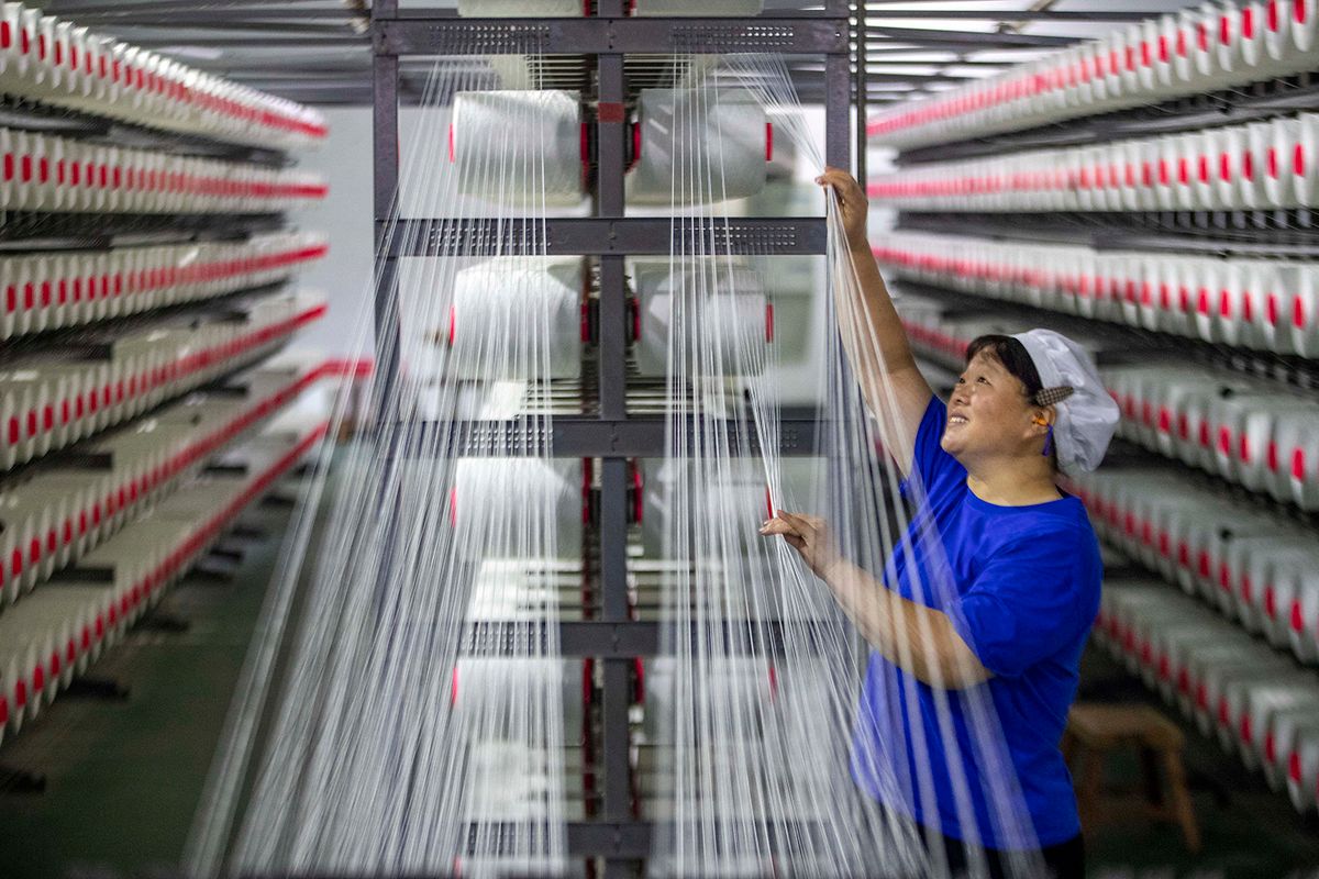 TAIZHOU, CHINA - SEPTEMBER 29, 2023 - A textile worker works on the production line of an enterprise in Taizhou, East China's Jiangsu Province, Sept 29, 2023. (Photo by Costfoto/NurPhoto) (Photo by CFOTO / NurPhoto / NurPhoto via AFP)