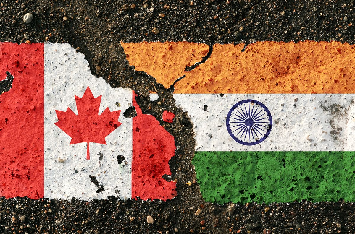 On,The,Pavement,Are,Images,Of,The,Flags,Of,Canada
On the pavement are images of the flags of Canada and India, as a symbol of the confrontation between countries. Conceptual image.