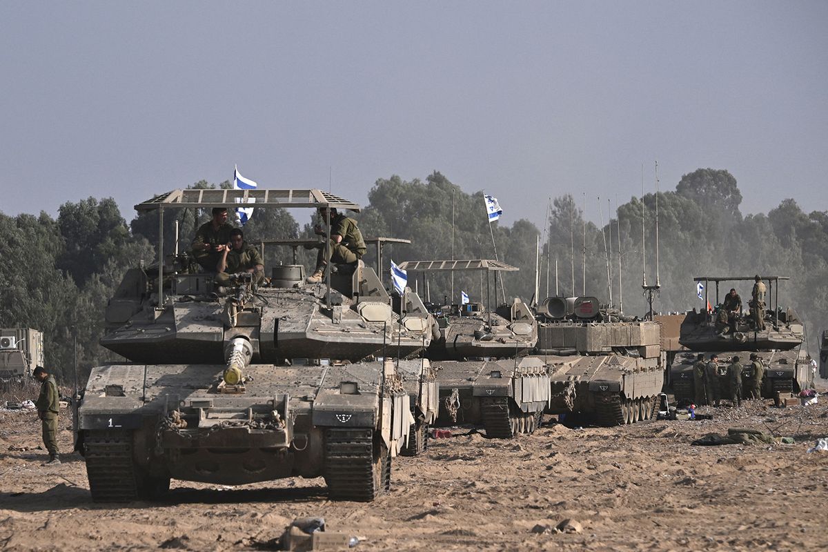 Israeli military armoured vehicles deploy along Israel's border with Gaza on October 24, 2023, amid the ongoing battles between Israel and the Palestinian group Hamas. Thousands of civilians, both Palestinians and Israelis, have died since October 7, 2023, after Palestinian Hamas militants based in the Gaza Strip entered southern Israel in an unprecedented attack triggering a war declared by Israel on Hamas with retaliatory bombings on Gaza. (Photo by Aris MESSINIS / AFP)