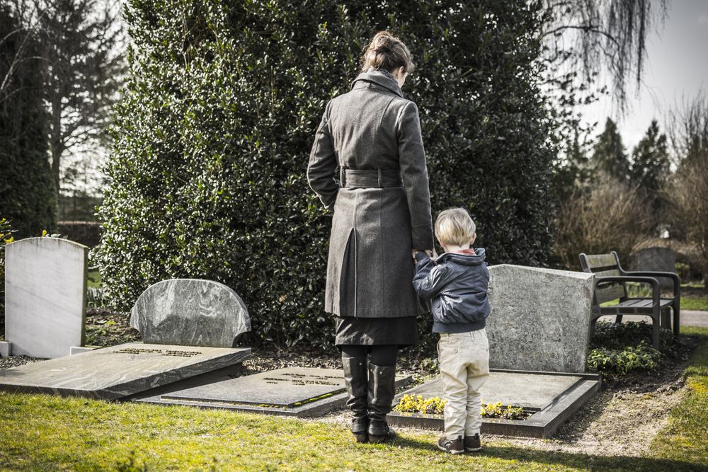 Woman,With,Child,At,Graveyard