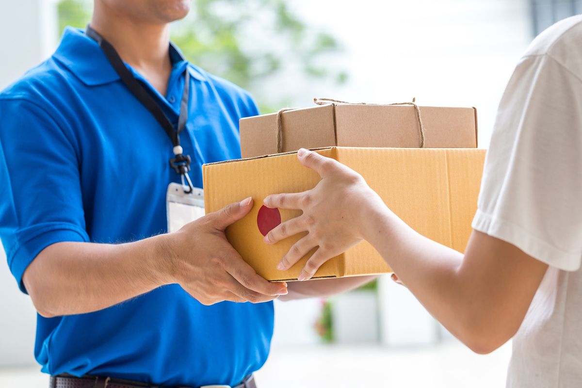 Woman,Hand,Accepting,A,Delivery,Of,Boxes,From,Deliveryman