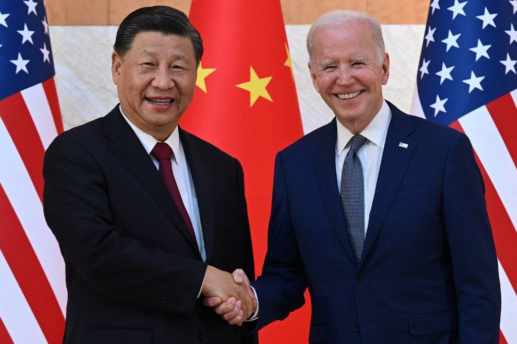 (FILES) US President Joe Biden (R) and China's President Xi Jinping (L) shake hands as they meet on the sidelines of the G20 Summit in Nusa Dua on the Indonesian resort island of Bali on November 14, 2022. China's top diplomat will pay a rare visit to Washington this week, the United States announced October 23, 2023, paving the way for a potential visit by President Xi Jinping aimed at keeping tensions in check. Foreign Minister Wang Yi, the highest-ranking Chinese official in the US capital in nearly five years, will visit from October 26 through October 28 against a backdrop of friction over trade, Ukraine, the Middle East, Taiwan and China's assertive actions at sea near the Philippines. (Photo by SAUL LOEB / AFP)