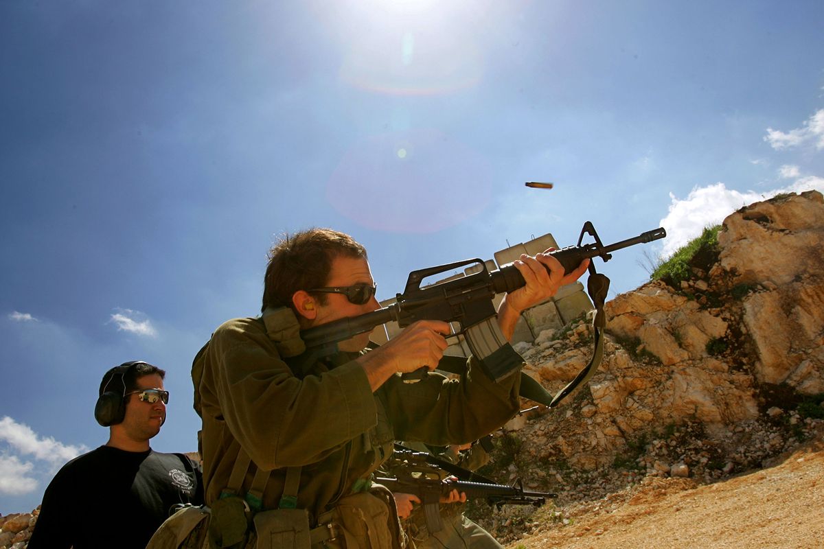 Israeli Army Reservists Hone Their Skills On The Shooting Range
WEST BANK: An Israeli army reservist, at the start of a month-long tour of duty, opens fire against targets on an unnamed military shooting range March 5, 2007 in the West Bank. The soldiers are from a reserve battalion which saw action seven months ago against Hezbollah militia in last summer's Lebanese war. They are once again finding themselves in uniform, this time operating against Palestinian militants and protecting Israeli settlements in the West Bank. (Photo by David Silverman/Getty Images)