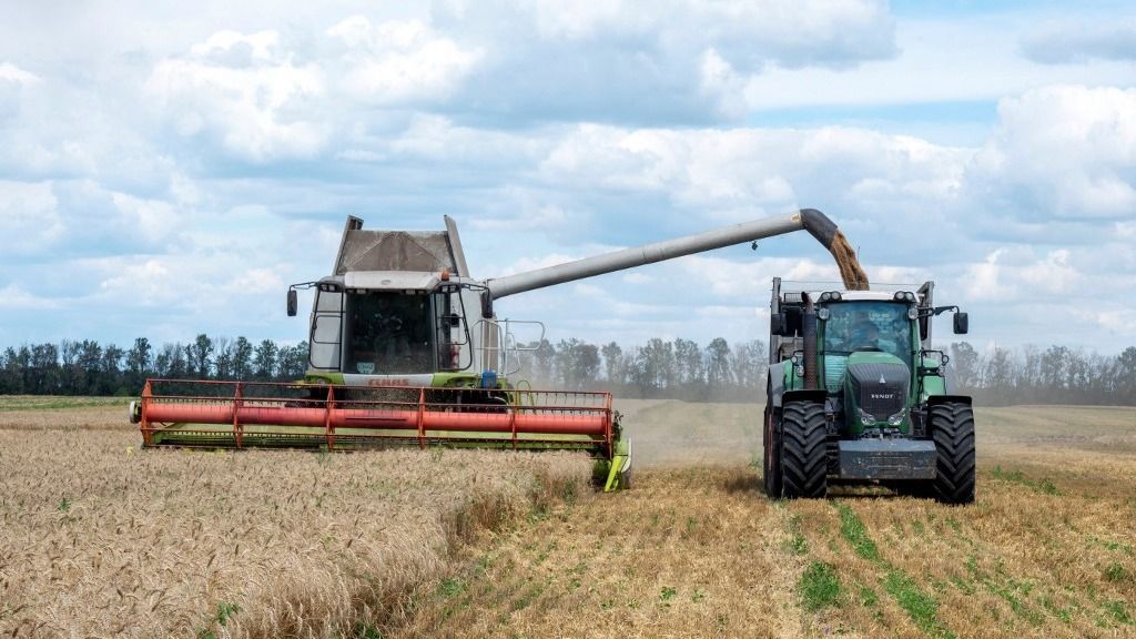 Farmers harvest a wheat field in the Ukrainian Kharkiv region on July 19, 2022, amid Russian invasion of Ukraine.
Russia and Ukraine on July 22, 2022 signed a landmark deal with the United Nations and Turkey on resuming grain shipments that could ease a global food crisis in which millions face hunger. (Photo by SERGEY BOBOK / AFP)