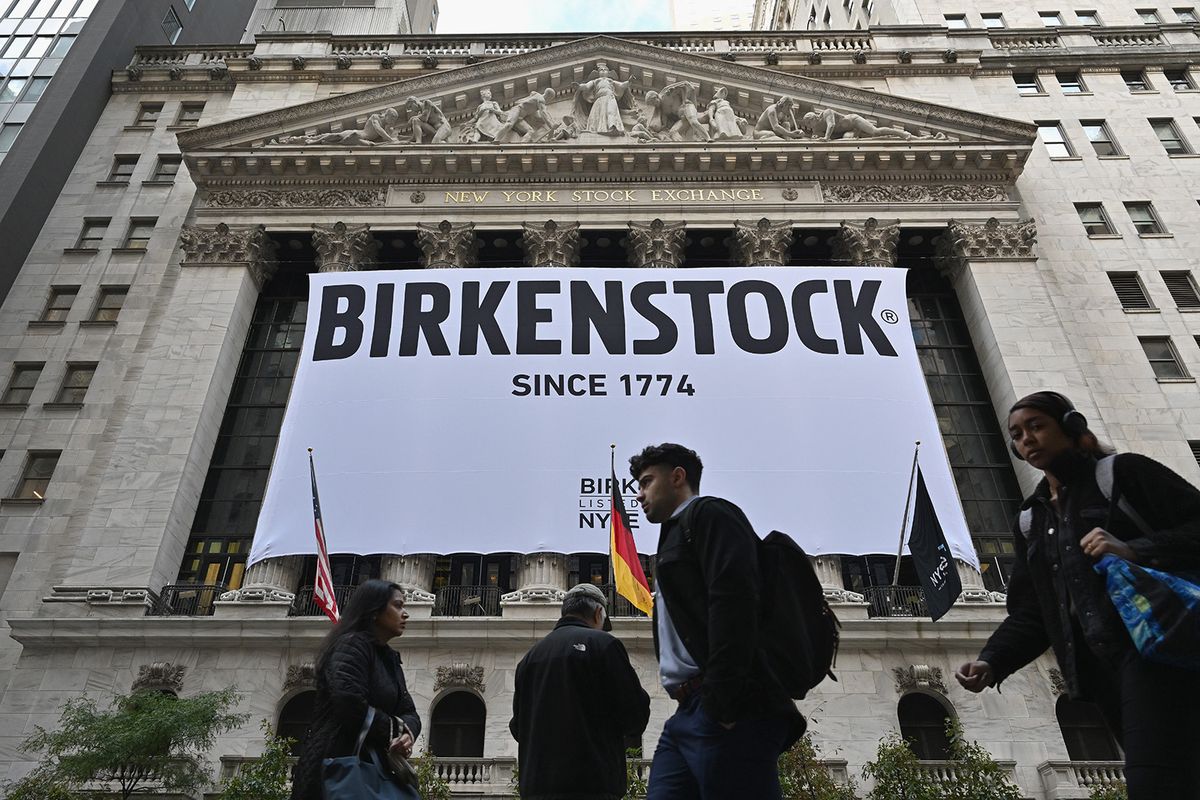 TOPSHOT - A Birkenstock banner hangs outside the New York Stock Exchange (NYSE) in New York on October 11, 2023, as Birkenstock launches an Initial Public Offering (IPO). German sandals maker Birkenstock has set its share price at $46, the firm said in a press release early Wednesday. A total of 32.26 million ordinary shares will be offered in its initial public offering, trading under the symbol BIRK. (Photo by ANGELA WEISS / AFP)
