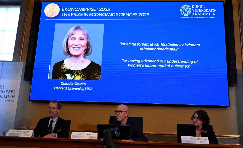 The winner of the 2023 Prize in Economic Sciences in Memory of Alfred Nobel American economist Claudia Goldin is seen on a display as (L-R) the chair of the Committee for the Prize in Economic Sciences in Memory of Alfred Nobel, Jakob Svensson, the Secretary General of the Royal Swedish Academy of Sciences Hans Ellegren and committee member Randi Hjalmarsson address a press conference at the Royal Swedish Academy of Sciences in Stockholm, Sweden, on October 9, 2023. The Nobel Economics Prize was awarded to American economist Claudia Goldin for helping understand women's opportunities in the labour market. (Photo by Jonathan NACKSTRAND / AFP)