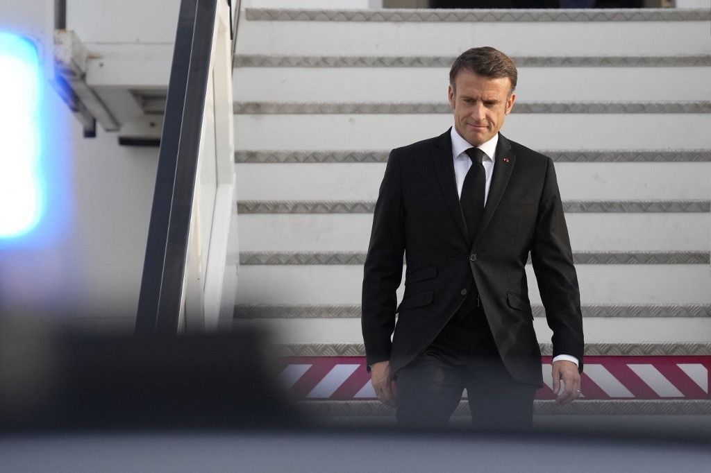 French President Emmanuel Macron arrives at the Ben Gurion airport in Tel Aviv on October 24, 2023. Macron's visit comes more than two weeks after Hamas militants stormed into Israel from the Gaza Strip and killed at least 1,400 people, mostly civilians who were shot, mutilated or burned to death on the first day of the raid, according to Israeli officials. (Photo by Christophe Ena / POOL / AFP)
