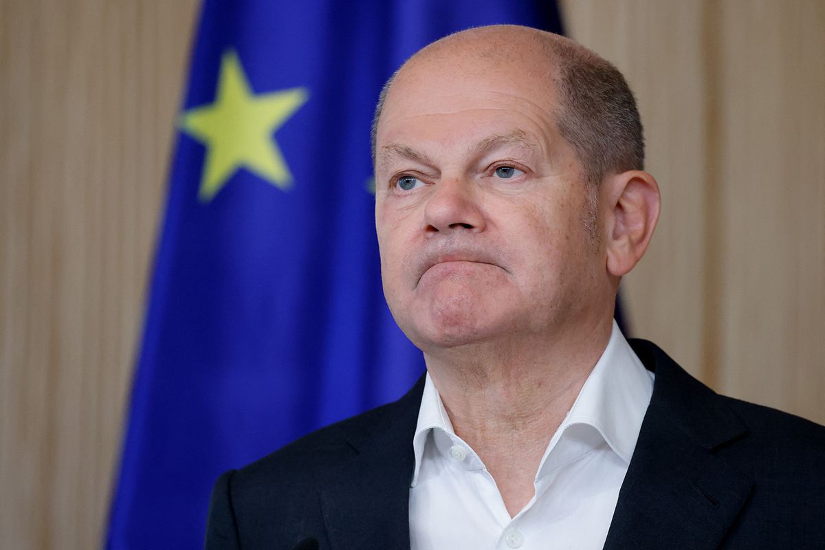 German Chancellor Olaf Scholz looks on as he stands next to the European flag while he and the French President address a joint press conference in Hamburg, northern Germany, on October 10, 2023, on the second day of two-day German-French government consultations. (Photo by Ludovic MARIN / AFP)