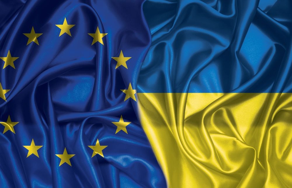 European,Union,And,Ukraine,Two,Folded,Silk,Flags,Together