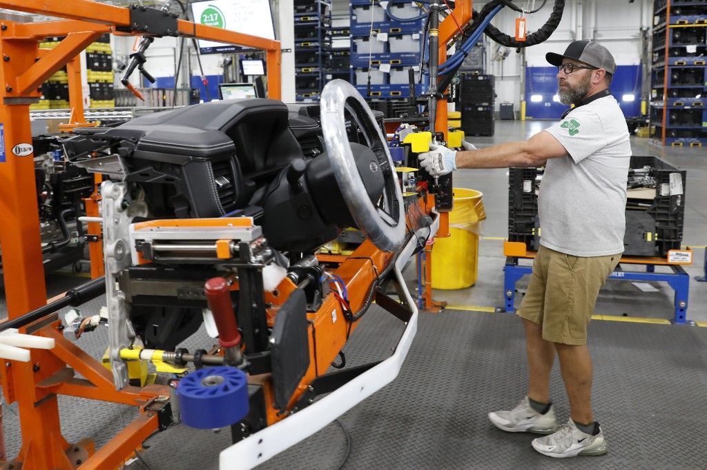 Ford's EV drive reboots historic Michigan factory once againA worker installs the instrument cluster for the Ford Motor Co. battery powered F-150 Lightning trucks under production at their Rouge Electric Vehicle Center in Dearborn, Michigan on September 20, 2022. Construction crews are back at Dearborn, remaking Ford's century-old industrial complex once again, this time for a post-petroleum era that is finally beginning to feel possible.
The manufacturing operation's prime mission in recent times has been to assemble the best-selling F-150, a gasoline-powered vehicle (Photo by JEFF KOWALSKY / AFP)