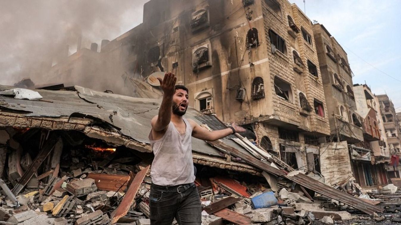 A man reacts outside a burning collapsed building following Israeli bombardment in Gaza City on October 11, 2023. At least 30 people have been killed and hundreds wounded as Israel pounded the Gaza Strip with hundreds of air strikes overnight, a Hamas government official said on October 11. The Israeli military confirmed it had hit several Hamas targets during the night in the Palestinian enclave. (Photo by MOHAMMED ABED / AFP)