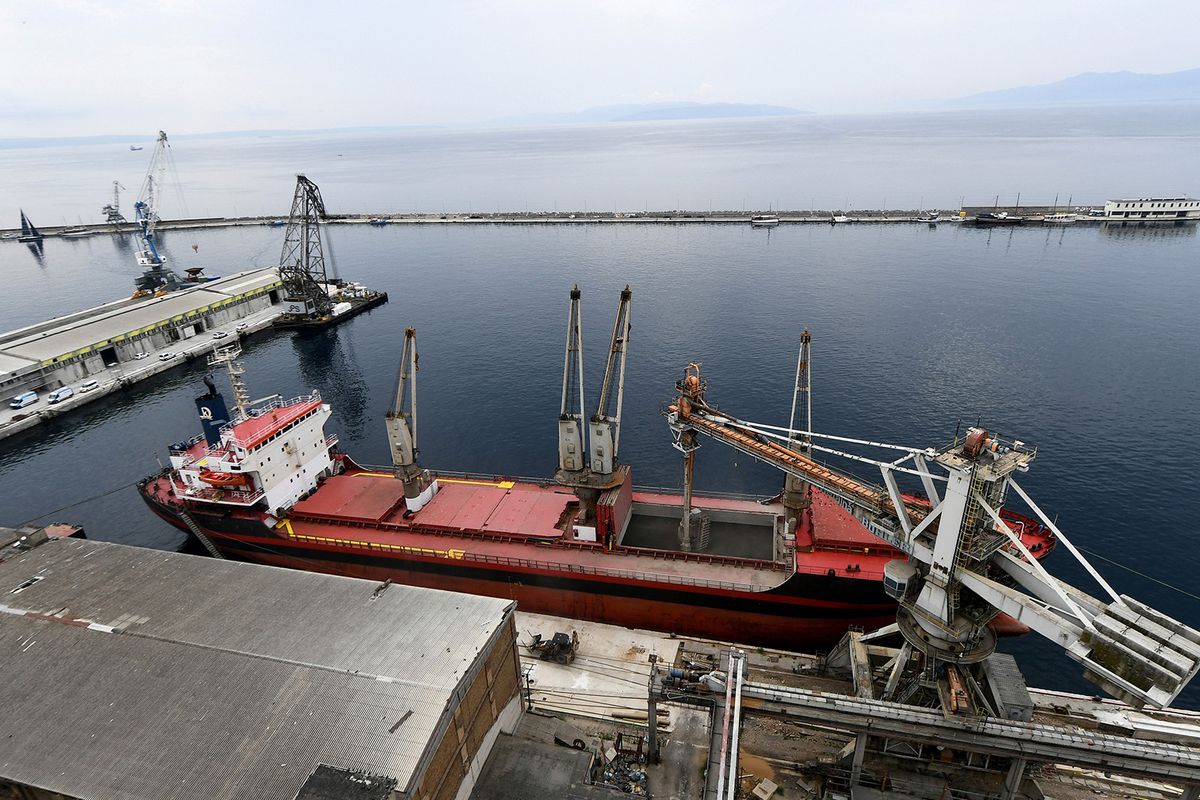 This photograph taken on September 18, 2023, shows a Turkish ship sailing under the Panamaian flag loading Ukrainian grain from silos in the port of Rijeka in Croatia. Ukraine has been exporting grain through the northern Croatian port of Rijeka for more than a year as Zagreb aims to increase exports of the war-wracked country's crops. Despite being hundreds of miles from Ukraine's western border, Croatia has become an unlikely transit point for the country's grains due to the ongoing Black Sea blockade by the Russians. Approximately 100,000 tons of Ukrainian corn and wheat have been exported from Rijeka port since May 2022. (Photo by Denis LOVROVIC / AFP)