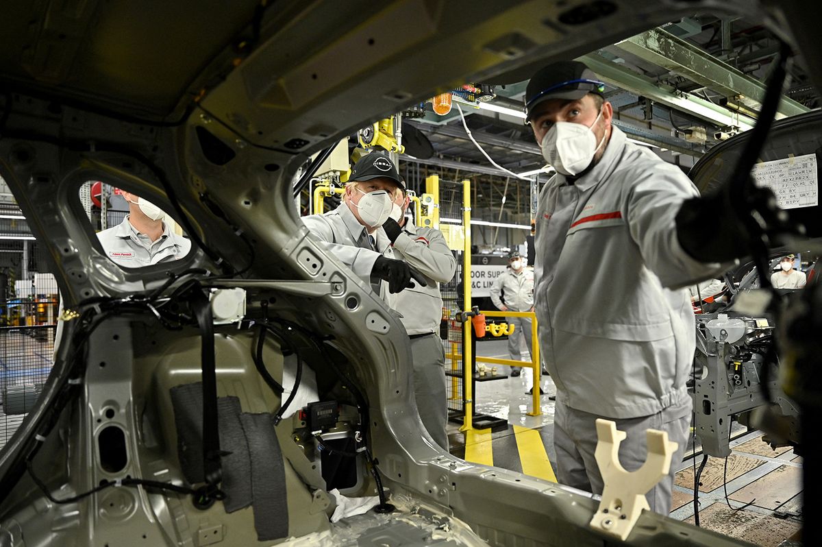 Britain's Prime Minister Boris Johnson tours Japanese auto giant Nissan's production plant in Sunderland, north east England on July 1, 2021. Nissan today announced plans to build the UK's first car-battery "gigafactory", where it will build a new electric vehicle. (Photo by Jeff J Mitchell / POOL / AFP)