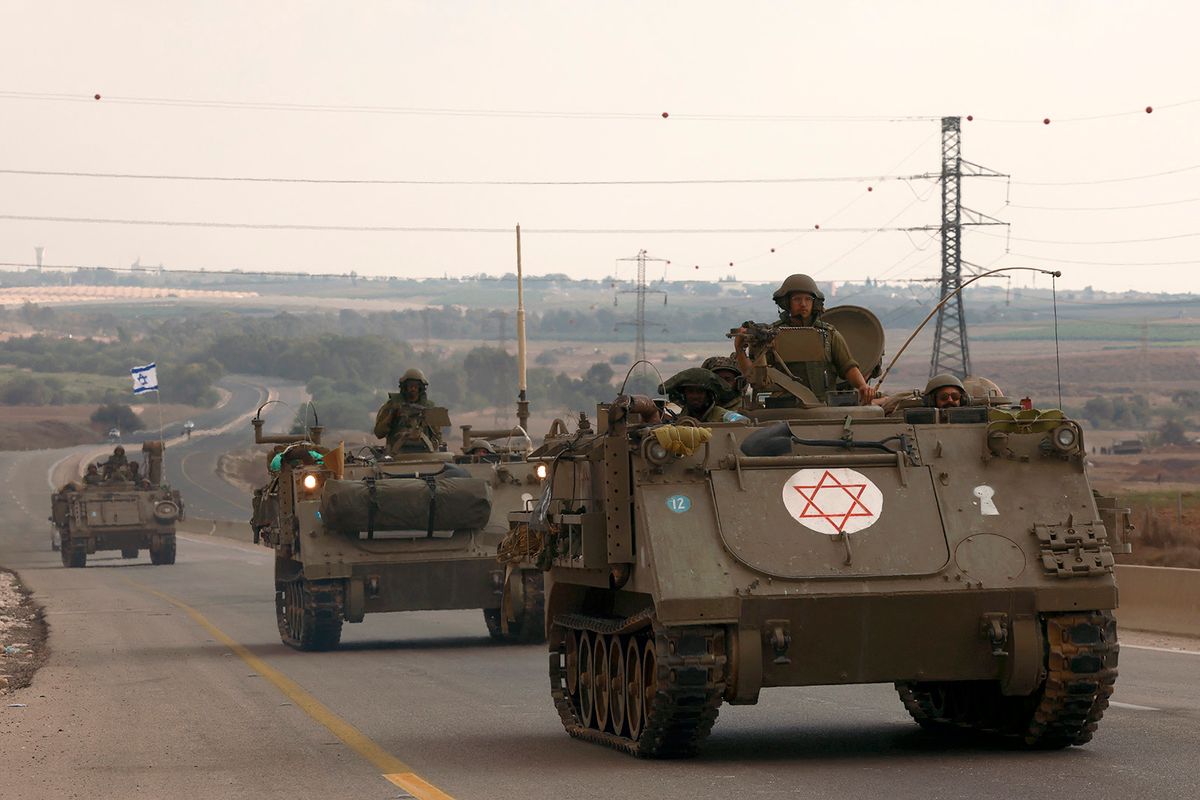 Israeli soliders ride in their armoured vehicles towards the border with the Gaza Strip on October 16, 2023, amid the ongoing battles between Israel and the Palestinian group Hamas. Thousands of people, both Israeli and Palestinians have died since October 7, 2023, after Palestinian Hamas militants based in the Gaza Strip, entered southern Israel in a surprise attack leading Israel to declare war on Hamas in Gaza on October 8. (Photo by Menahem KAHANA / AFP)