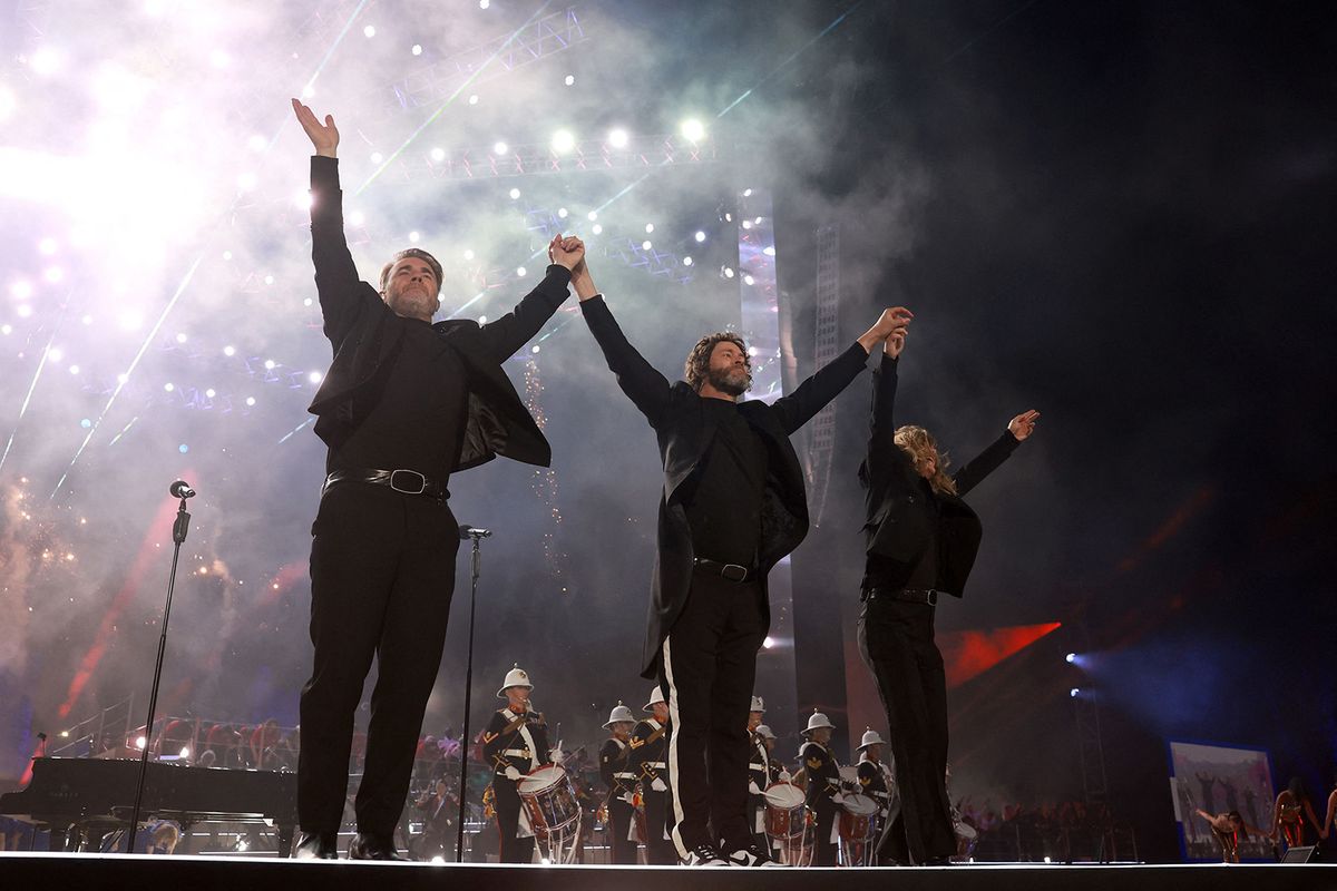 Gary Barlow (L), Howard Donald (C) and Mark Owen (R) of Take That perform inside Windsor Castle grounds at the Coronation Concert, in Windsor, west of London on May 7, 2023. For the first time ever, the East Terrace of Windsor Castle will host a spectacular live concert that will also be seen in over 100 countries around the world. The event will be attended by 20,000 members of the public from across the UK. (Photo by Chris Jackson / POOL / AFP)