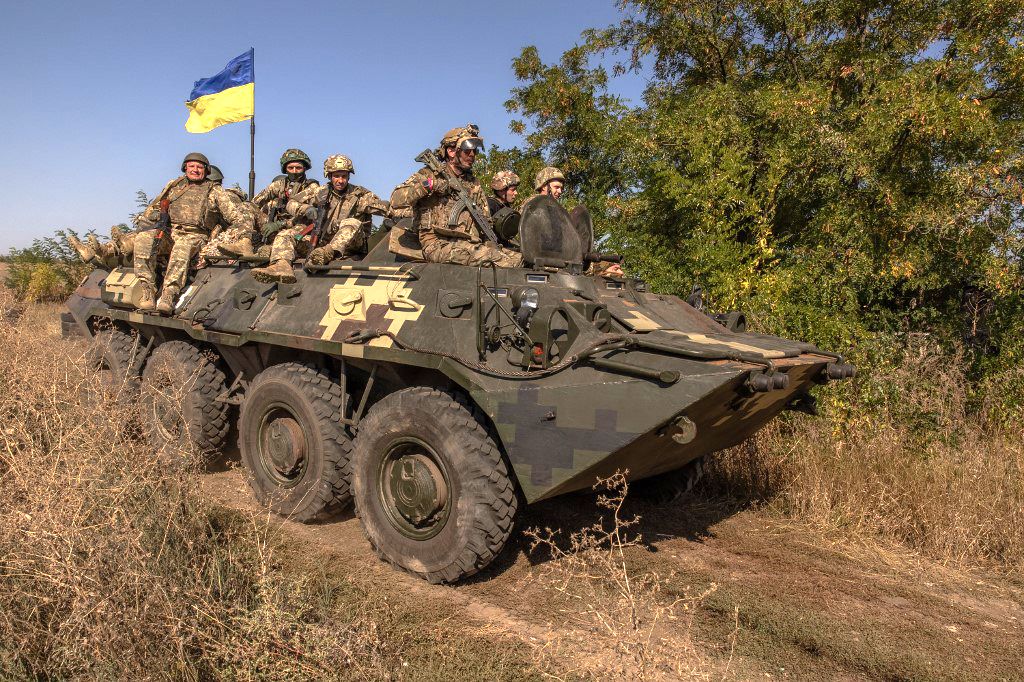 UKRAINE-RUSSIA-CONFLICT-WARUkrainian members of the OPFOR (opposing force) battalion ride on top of an armoured personnel carrier as they take part in a military training in the Donetsk region on September 26, 2023, amid the Russian invasion of Ukraine. (Photo by Roman PILIPEY / AFP)