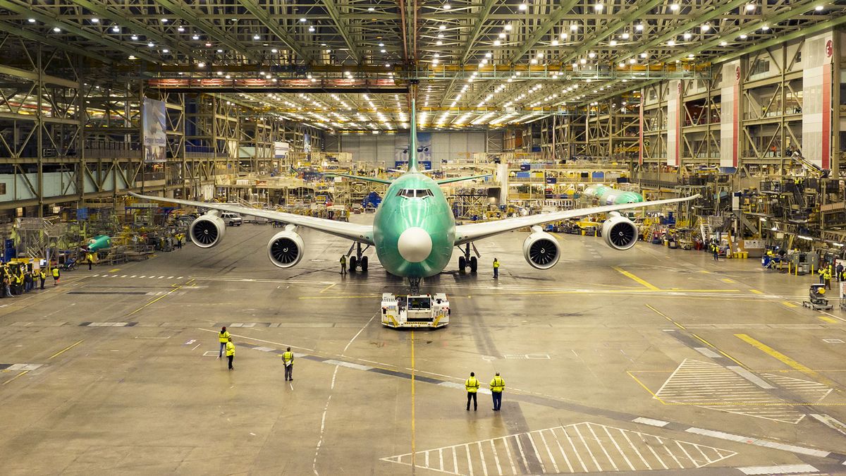 This handout photo taken on December 7, 2022, and released by Boeing on January 31, 2023, shows the last Boeing 747-8 departing the company's widebody factory in Everett, Washington, ahead of its early delivery to Atlas Air.  2023. Boeing is set to officially bid farewell to the original jumbo jet, the 747, as it makes its final commercial delivery of the plane that democratized aviation and serves US presidents.  Thousands of current and former employees will gather on January 31 at the Boeing plant in Everett, Washington, in the northwestern part of the United States, to celebrate the final farewell in parallel with the delivery of the Boeing 747-8 freighter to Atlas Air.  (Photo by Paul Weatherman/Boeing/AFP) / Restricted for editorial use - mandatory credit "Photo by AFP/Paul Weatherman/Boeing " - No marketing, no advertising campaigns - it is distributed as a service to customers