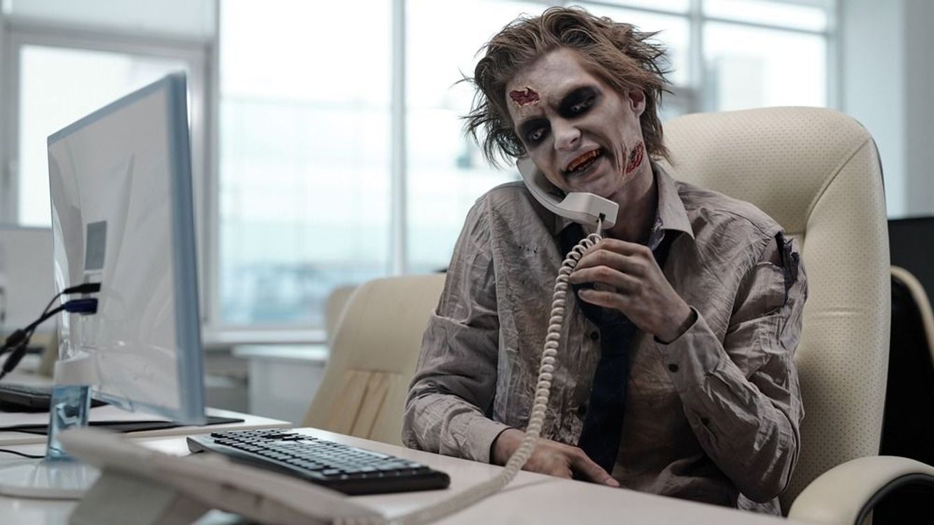 Zombie,Businessman,With,Phone,Receiver,Between,His,Shoulder,And,Cheek