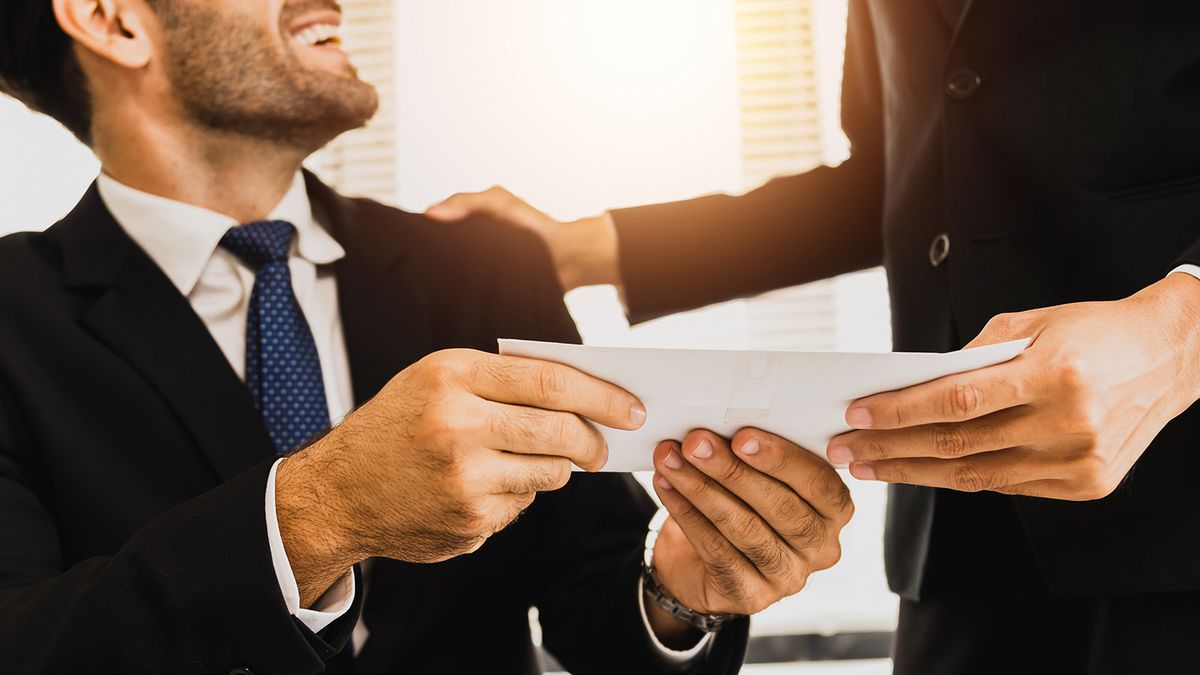 close up hand of employee receive bonus from manager