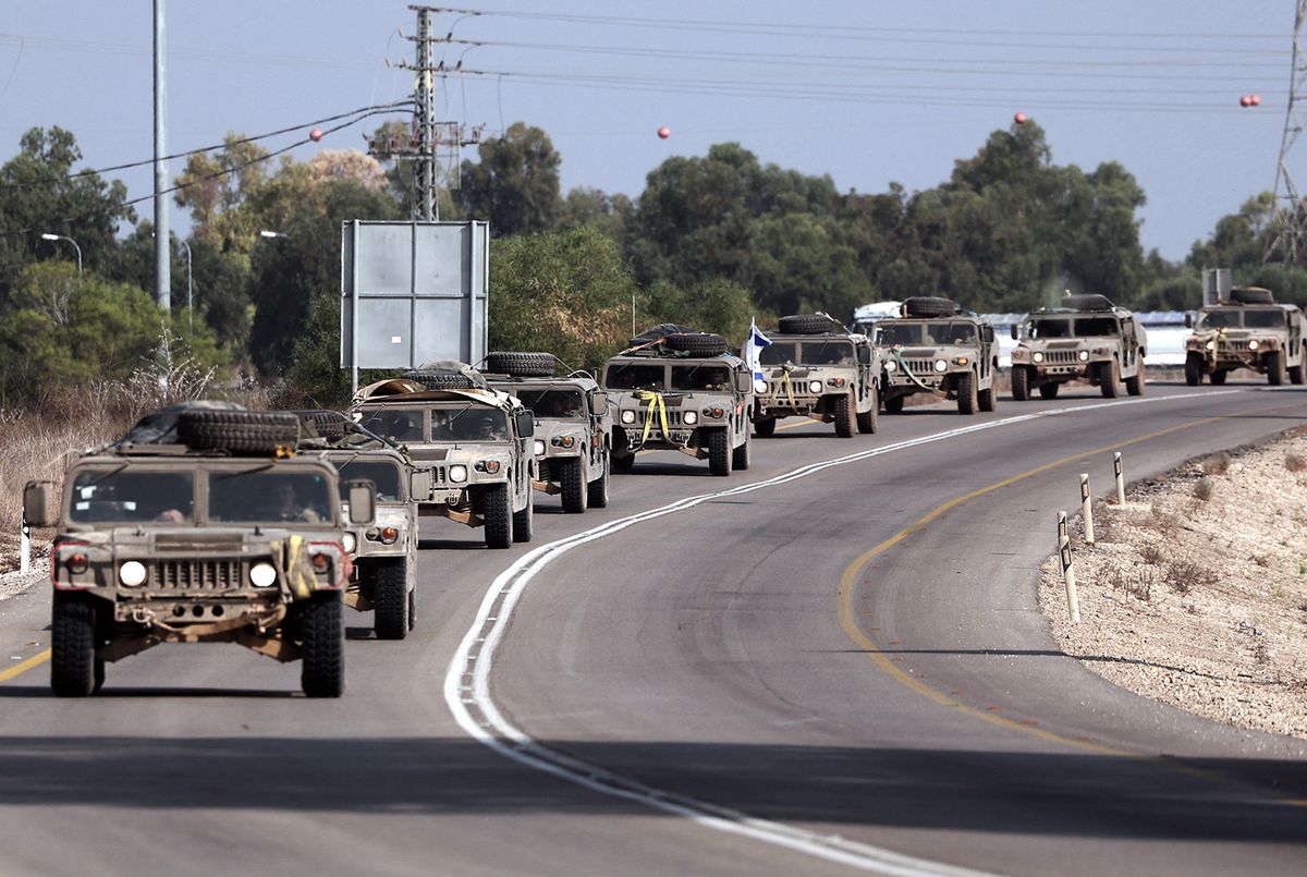 EDITORS NOTE: Graphic content / A convoy of Israeli army vehicles drive along a road close to the southern Israeli city of Sderot on October 23, 2023, amid the ongoing battles between Israel and the Palestinian group Hamas. Thousands of people, both Israeli and Palestinians have died since October 7, 2023, after Palestinian Hamas militants based in the Gaza Strip, entered southern Israel in a surprise attack leading Israel to declare war on Hamas in Gaza on October 8. (Photo by Thomas COEX / AFP)