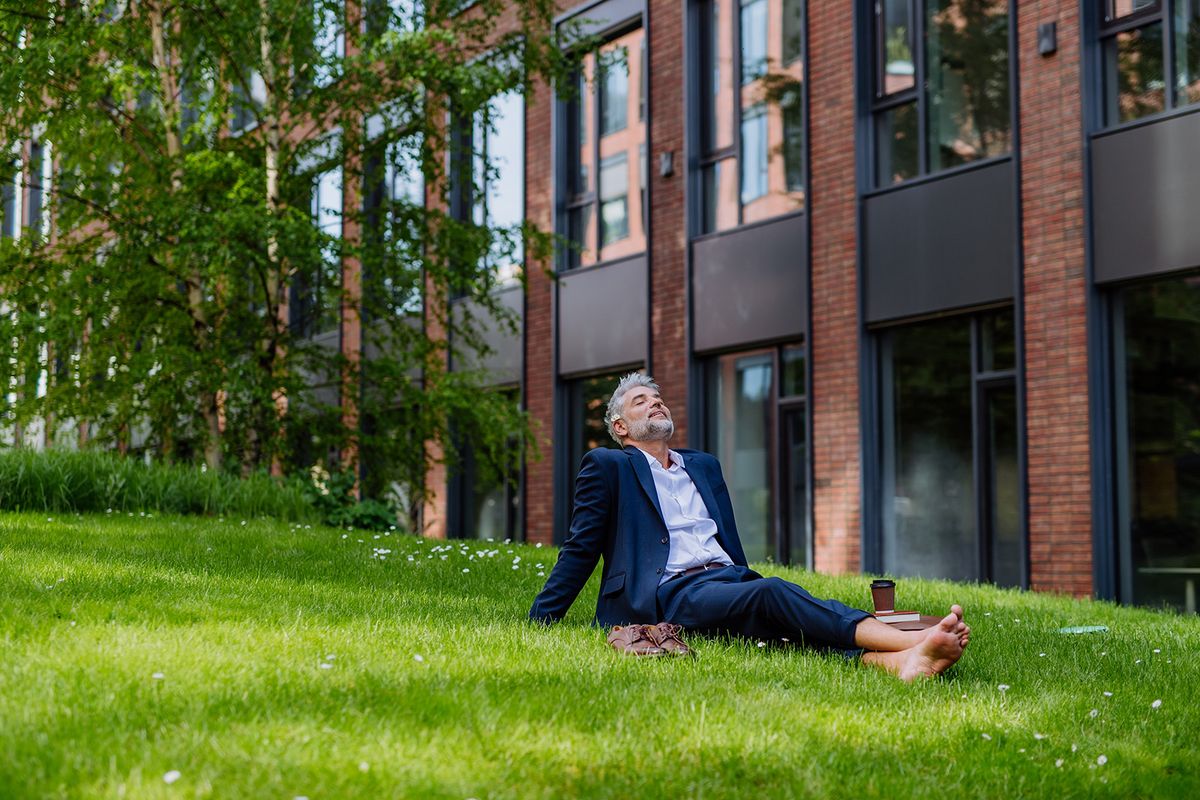 Mature,Businessman,Resting,And,Sitting,Barefoot,In,Park,,Feeling,Free,