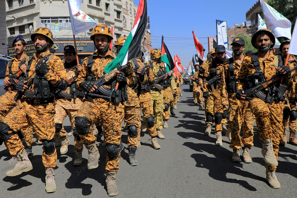 Armed forces loyal to Yemen's Huthi rebels march through the streets of Sanaa in a show of solidarity with the Palestinians on October 15, 2023. Thousands of protesters poured onto the streets of several Middle East capitals on the Muslim weekend in support of Palestinians amid Israeli air strikes on Gaza in reprisal for a surprise Hamas attack on Israel in which more than 1,300 people were killed. Israeli forces have responded with heavy bombardment of Gaza, where authorities say more than 2,300 people have been killed. (Photo by MOHAMMED HUWAIS / AFP)