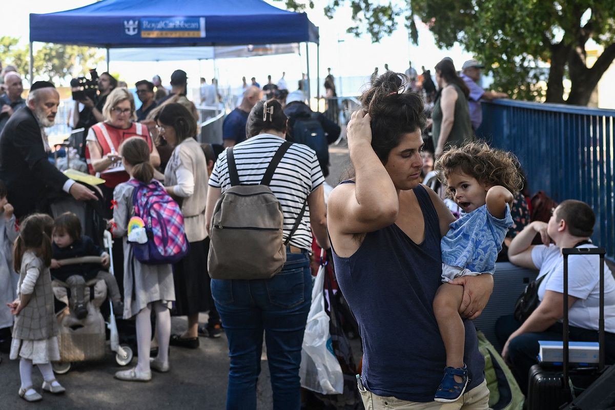 US citizens wait at the port of Haifa to be evacuated to Cyprus on October 16, 2023, amid the ongoing battles between Israel and the Palestinian Islamist group Hamas. Israel declared war on Hamas a day after waves of its fighters broke through the heavily fortified border on October 7, shooting, stabbing and burning to death more than 1,400 people, most of them civilians. Israel then unleashed a relentless bombing campaign of Gaza that has flattened neighbourhoods and left at least 2,670 people dead in the territory, mainly civilians. (Photo by Aris MESSINIS / AFP)