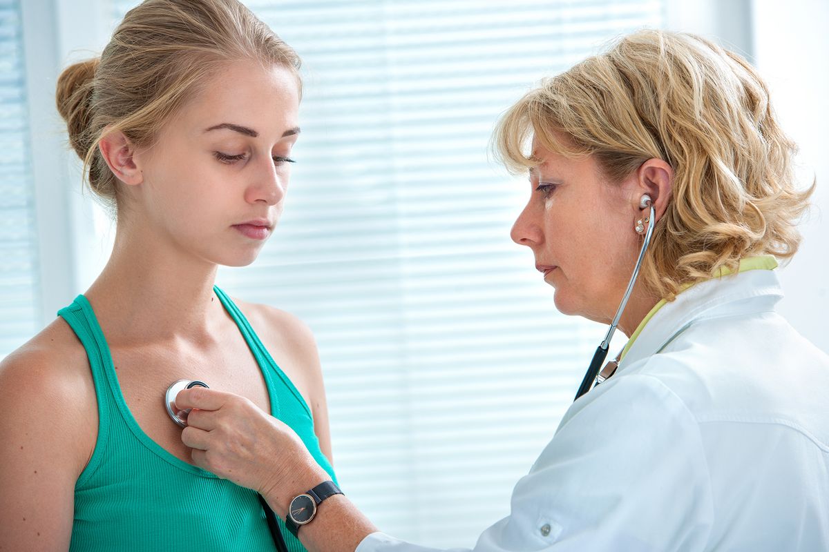 Female,Doctor,Examining,Teenage,Girl,With,Stethoscope