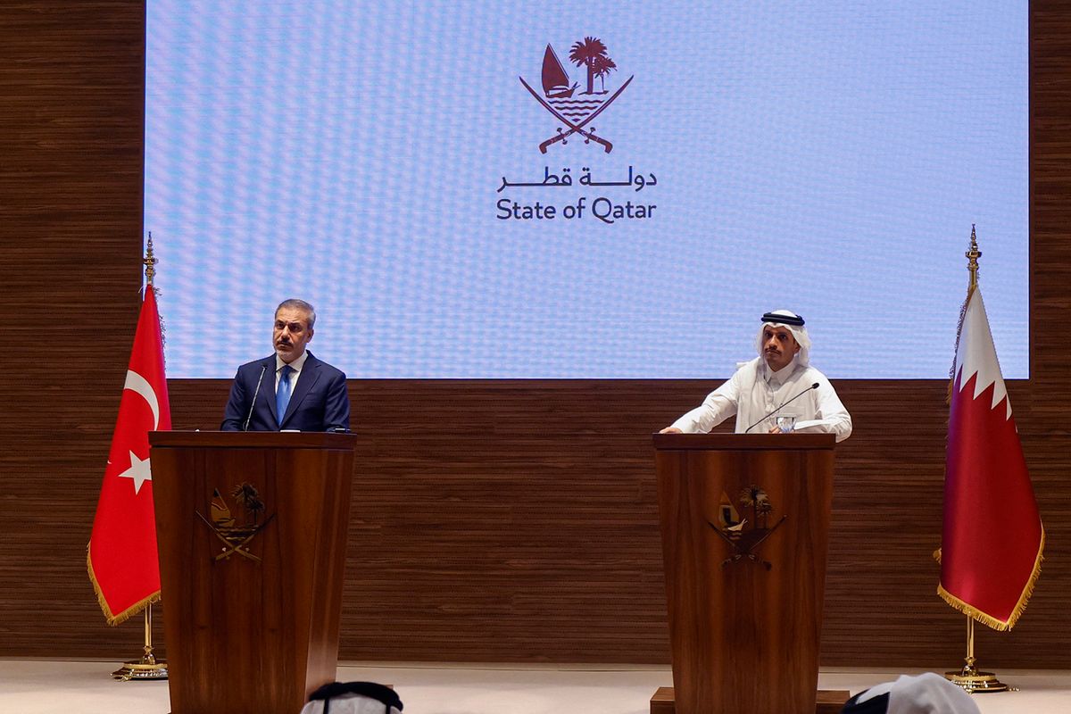 Qatar's Prime Minister and Foreign Minister Mohammed bin Abdulrahman al-Thani (R) and Turkey's Foreign Minister Hakan Fidan hold a press conference in Doha on October 25, 2023. (Photo by KARIM JAAFAR / AFP)