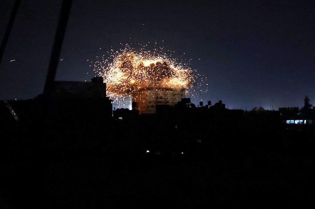 PALESTINIAN-ISRAEL-GAZA-CONFLICTSmoke and fire billow from a building after an explosion in Rafah, South Gaza Strip on October 19, 2023. Egyptian President Abdel Fattah al-Sisi has agreed to open the Rafah crossing into Gaza to allow a first batch of around 20 humanitarian aid trucks through, US President Joe Biden said October 18, 2023. (Photo by Mohammed ABED / AFP)