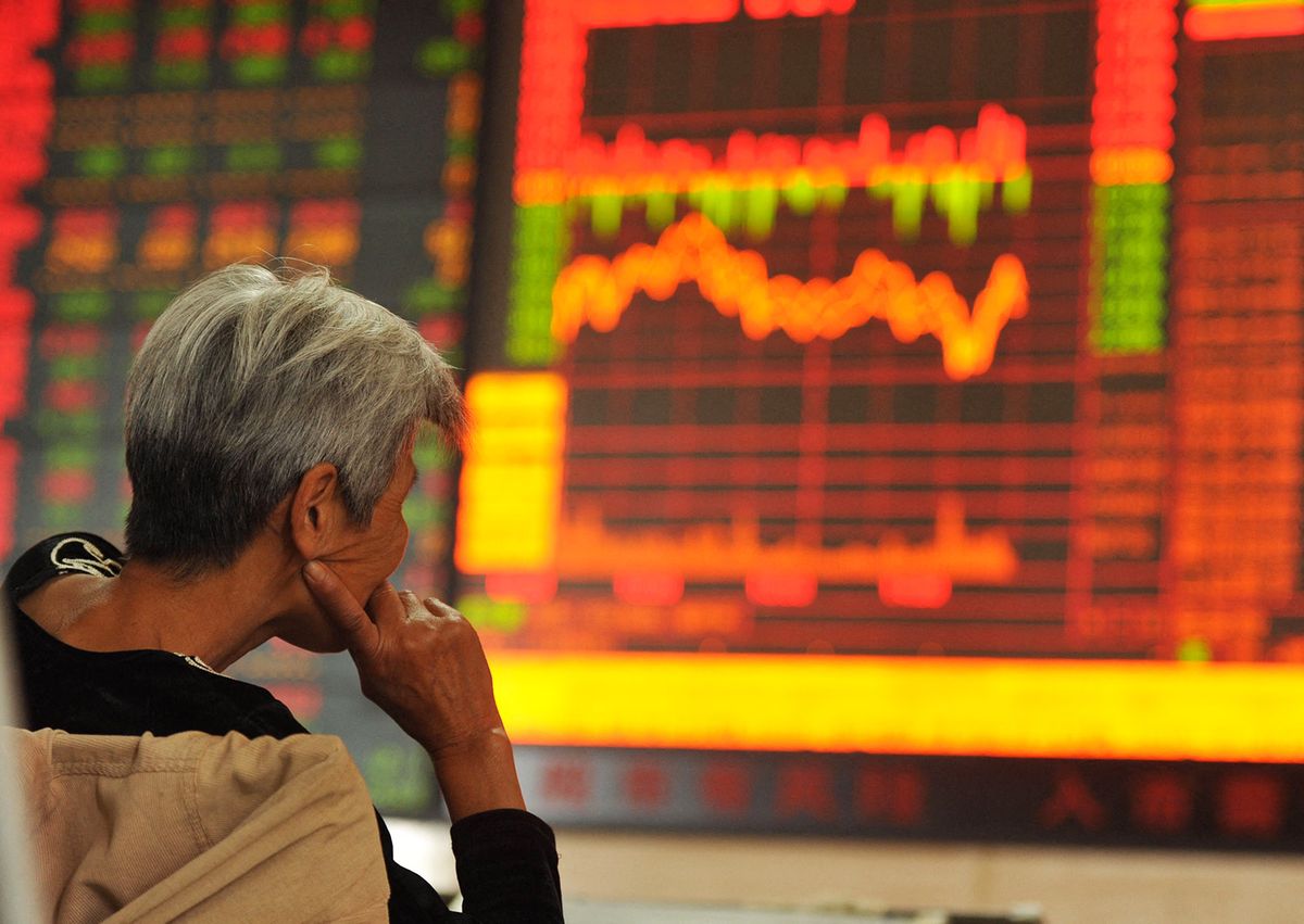 A concerned Chinese investor looks at a stock index at a stock brokerage house in Fuyang city, east China's Anhui province, 29 September 2015.China stocks fell around 2.02 percent on Tuesday (28 September 2015), led by energy and commodity-related shares as Chinese investors joined a global equity selloff triggered by fears of a sharp slowdown in the world economy. But trading remained thin - daily trading volume in Shanghai was just one-fifth of its early-June peak - reflecting a general "risk-off" mood ahead of a seven-day National Day Holiday that starts on Thursday. Official factory and service sector activity surveys will also be published on Thursday. (Photo by An xin / Imaginechina / Imaginechina via AFP)