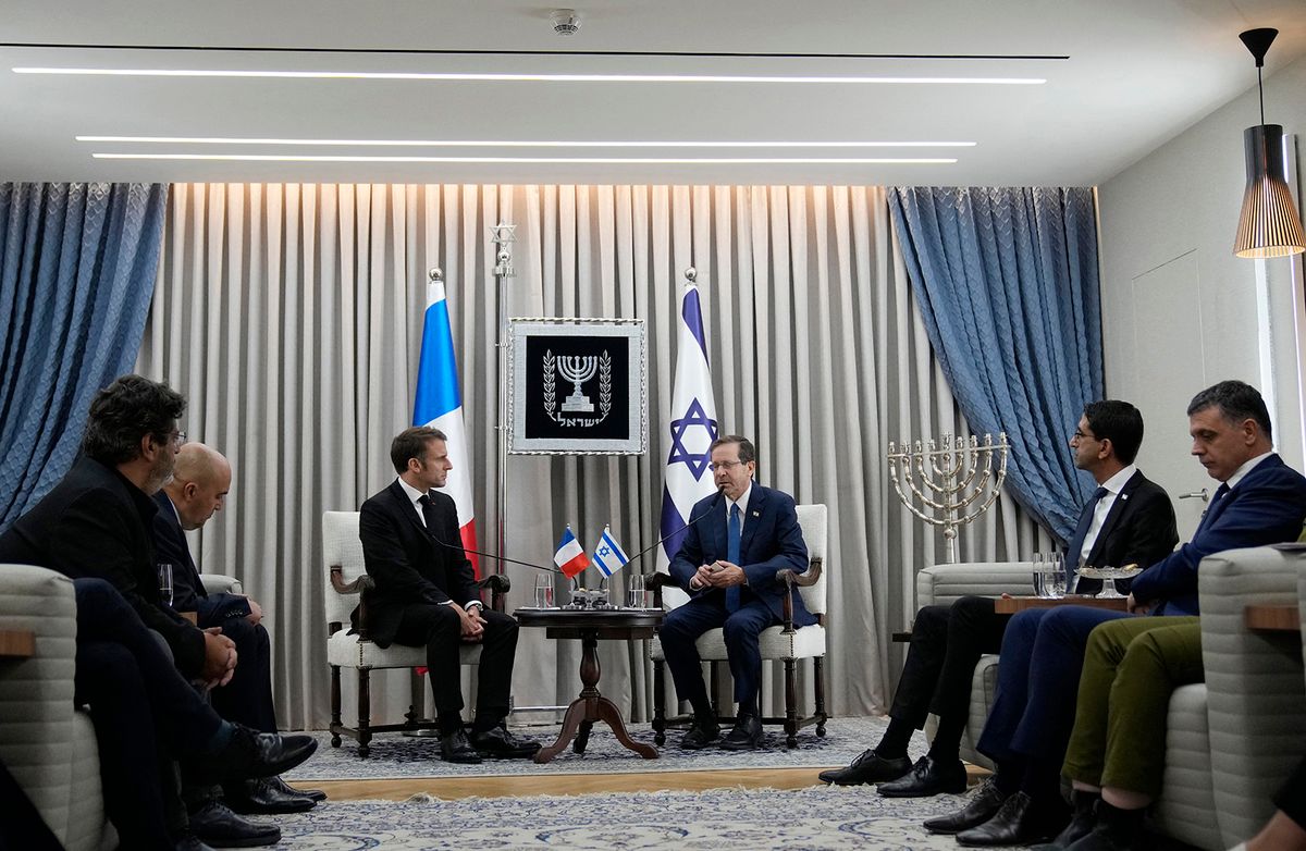 French President Emmanuel Macron (L) meets Israel's President Isaac Herzog in Jerusalem, on October 24, 2023. Macron's visit comes more than two weeks after Hamas militants stormed into Israel from the Gaza Strip and killed at least 1,400 people, mostly civilians who were shot, mutilated or burned to death on the first day of the raid, according to Israeli officials. (Photo by Christophe Ena / POOL / AFP)