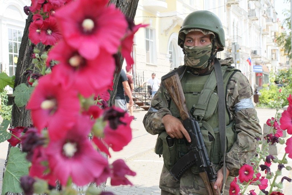 Wagner group fighters on street in Rostov-on-DonROSTOV-ON-DON, RUSSIA - JUNE 24: A member of Wagner group stands guard in a street after Wagner chief Yevgeny Prigozhin's statement in Rostov-on-Don, Russia on June 24, 2023. The Wagner paramilitary group has taken control of the headquarters of Russia's southern military district in Rostov-Na-Don, according to the group’s leader on Saturday. Stringer / Anadolu Agency (Photo by STRINGER / ANADOLU AGENCY / Anadolu Agency via AFP)