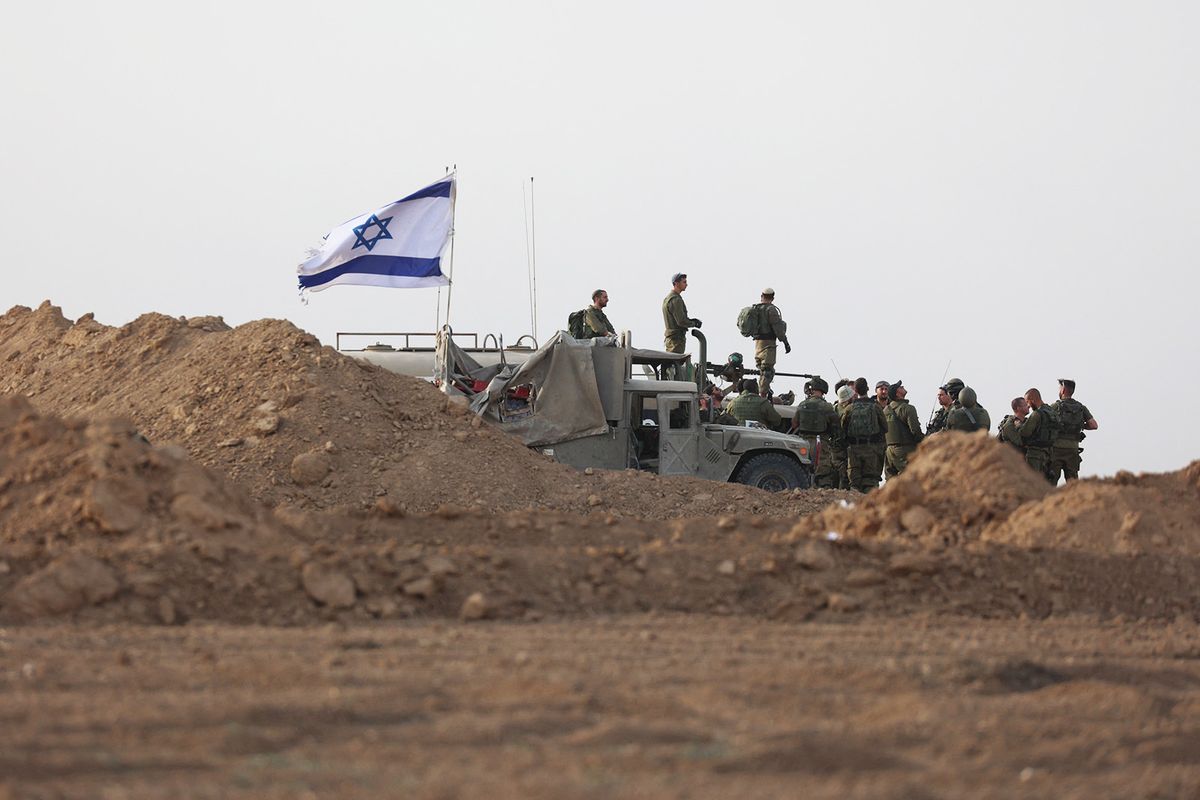 Israeli troops gather near the border with Gaza before entering the Palestinian strip on October 29, 2023, amid ongoing battles between Israel and the Palestinian Hamas movement. (Photo by Gil COHEN-MAGEN / AFP)