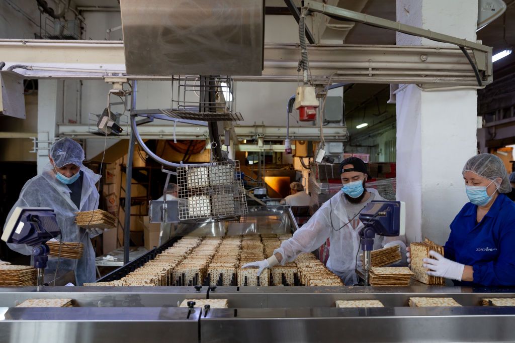 Coronavirus Cases Rise As Israel Struggles To Enforce Quarantine In Ultra-Orthodox TownsTEL AVIV, ISRAEL - APRIL 07: Workers making matzah for Passover at Matzot Aviv factory with masks and gloves on April 07, 2020 in Bnei Brak, Israel. There are about 10,000 reported cases of COVID-19 in the country, with several dozen deaths. (Photo by Guy Prives/Getty Images)