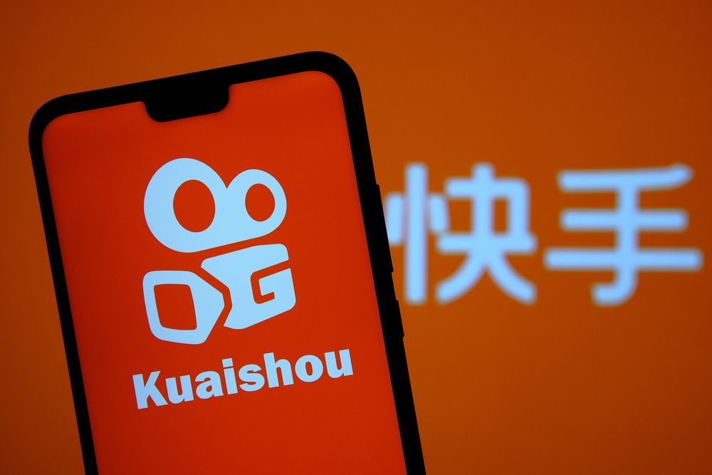 Kuaishou,App,Logo,Seen,On,The,Smartphone,Screen,And,Blurred
