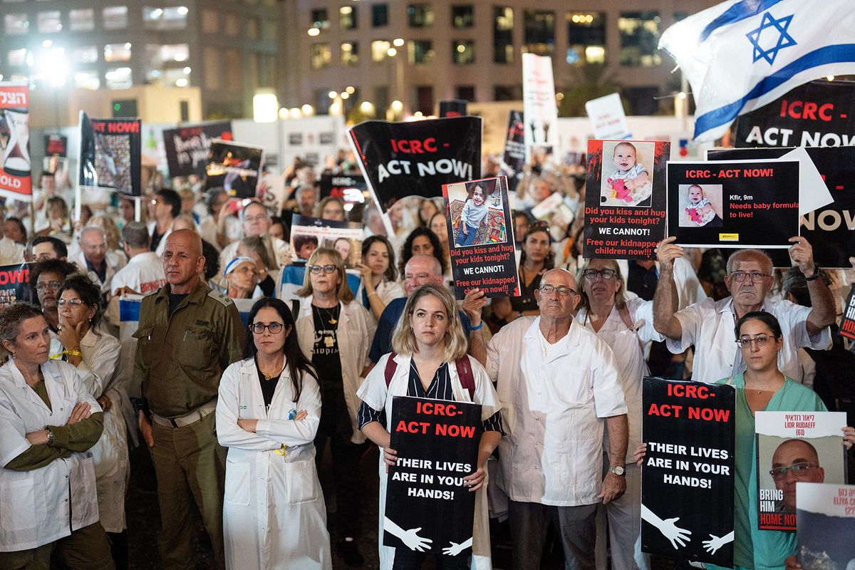 11/09/2023 Tel Aviv, Israel. People hold signs and photos calling red cross to help them release the hostages .Israeli doctors residents hold photographs and signs of the kidnapped people held hostage by Hamas militants in Gaza, as they protest outside the Red Cross headquarters in Tel Aviv, November 9, 2023. (Photo by Dima Vazinovich / Middle East Images / Middle East Images via AFP)