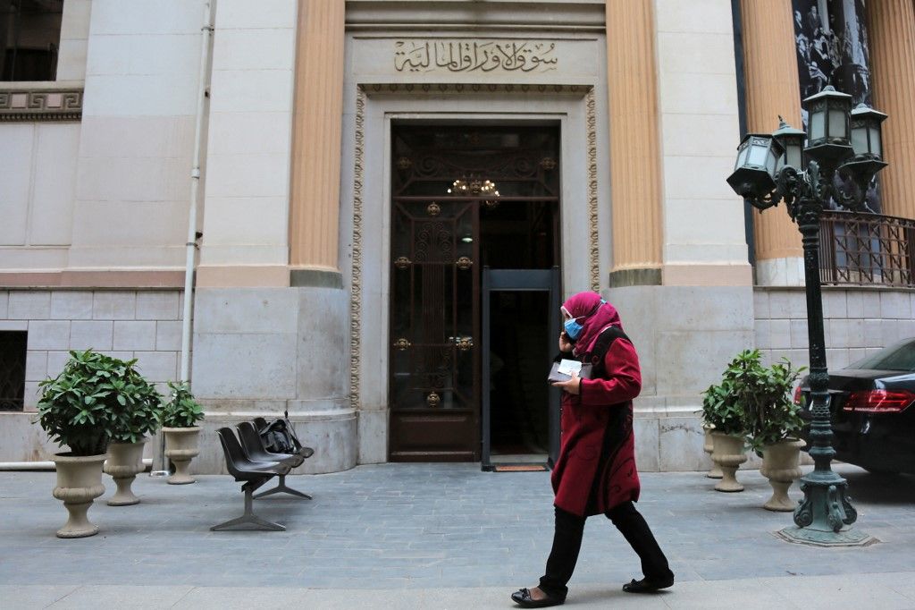 Egyptian Stock ExchangeA woman wears a face mask as she passes in front of one of the Egyptian stock exchange, Amid the spread of the coronavirus (COVID-19) pandemic. on December 23, 2020 in Cairo, Egypt. (Photo by Fadel Dawod/NurPhoto) (Photo by Fadel Dawod / NurPhoto / NurPhoto via AFP)