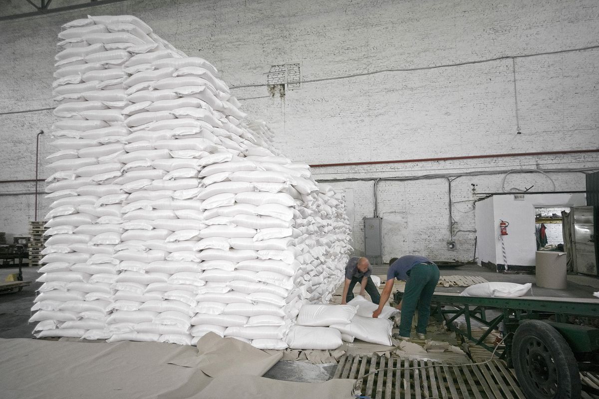 Workers load bags of refined white sugar onto an elevator at the ED&F Man Ltd. refinery in Nikolaev, Ukraine, on Friday, Sept. 22, 2017. More sugar is coming to the world market from October, when the European Union ends a system of quotas that capped production and exports. Photographer: Vincent Mundy/Bloomberg via Getty Images