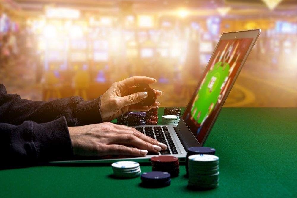 Woman,Hands,With,Gambling,Chips,Using,Laptop,For,Playing,Online