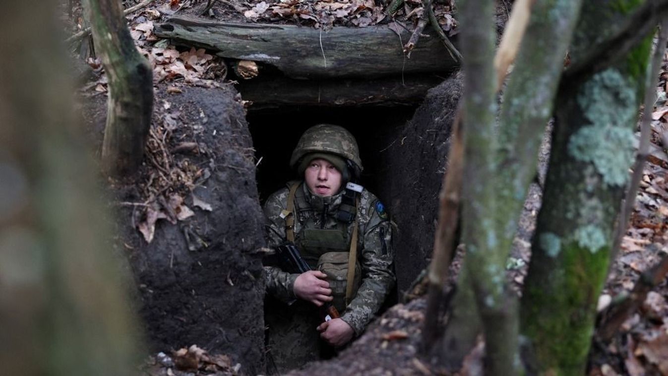 A Ukrainian serviceman looks out from an underground shelter on the frontline near the town of Bakhmut, Donetsk region, on November 18, 2023, amid the Russian invasion of Ukraine. (Photo by Anatolii STEPANOV / AFP)