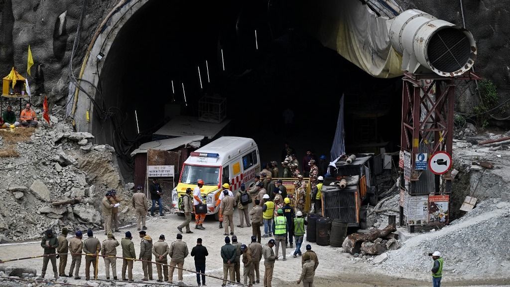 An ambulance and rescue operatives gather near the face of the collapsed under construction Silkyara tunnel in the Uttarkashi district of India's Uttarakhand state, on November 28, 2023. Indian rescue teams digging by hand are on the verge of breaking through to reach 41 men trapped in a collapsed road tunnel, officials said Tuesday, raising hopes the end of the marathon 17-day operation is in sight. (Photo by Sajjad HUSSAIN / AFP)