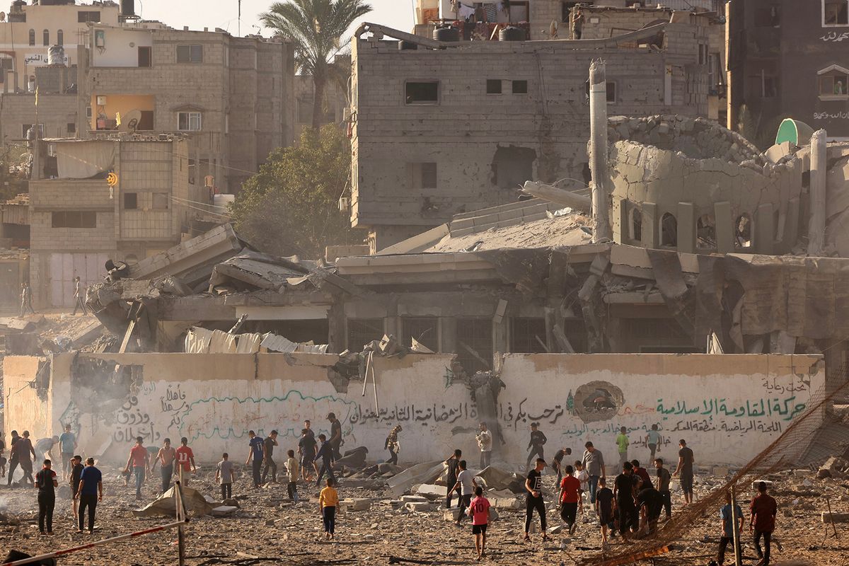 Palestinians inspect the debris at the Khaled Ibn Al-Walid mosque, after it was hit by Israeli bombardment, in Khan Yunis on November 8, 2023, amid ongoing battles between Israel and the Palestinian Hamas movement. (Photo by Mahmud HAMS / AFP)