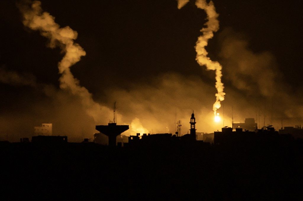 This picture taken from a position near Sderot along the Israeli border with the Gaza Strip early on November 13, 2023, shows flares dropped by Israeli forces above the Palestinian enclave amid ongoing battles between Israel and the Palestinian Hamas movement. (Photo by FADEL SENNA / AFP)